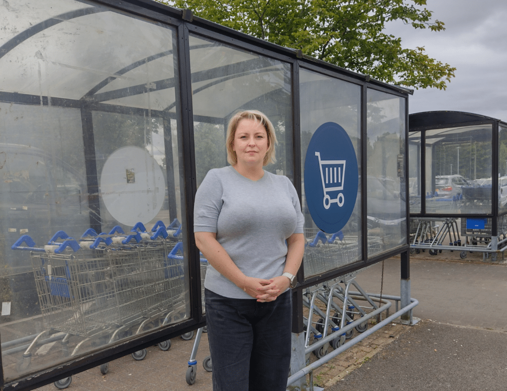 Police and Crime Commissioner Lisa standing by supermarket trolleys