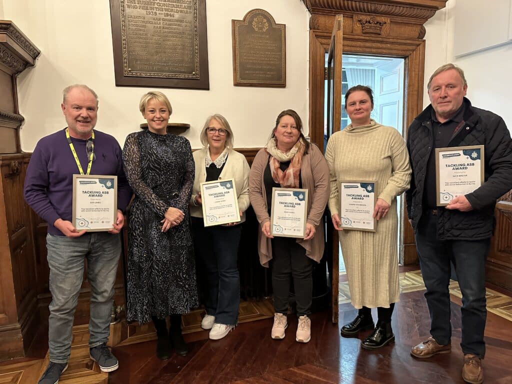 Lisa Townsend stands beside members of Catalyst Support's Cuckooing Service, who received awards at a Surrey Police ceremony to highlight efforts made to tackle anti-social behaviour.